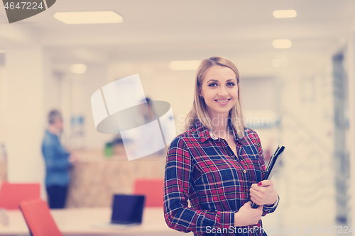 Image of portrait of young business woman at office with team in backgrou