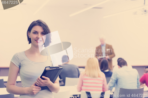 Image of portrait of happy female student in classroom