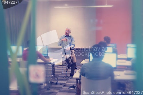 Image of teacher and students in computer lab classroom