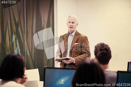 Image of teacher and students in computer lab classroom