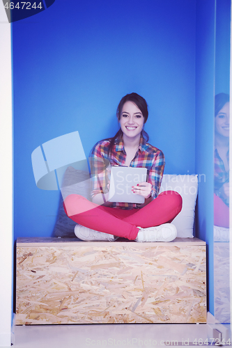 Image of woman in crative box working on tablet