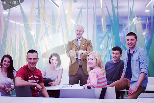 Image of portrait of  teacher with students group in background