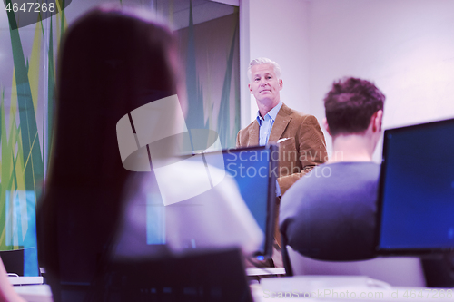 Image of teacher and students in computer lab classroom