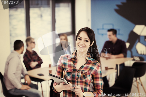 Image of portrait of young business woman at office with team in backgrou