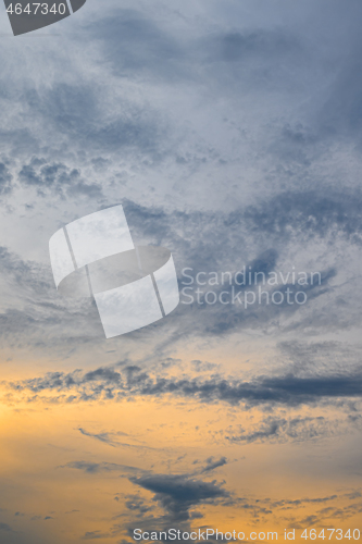Image of Blue, yellow and orange sunset with clouds