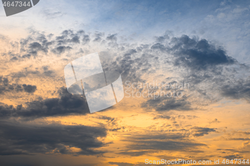 Image of Blue, yellow and orange sunset with clouds