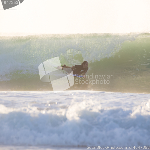 Image of Body surfer riding a perfect wave.