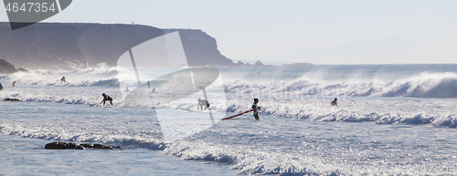 Image of Surfers surfing on El Cotillo beach, Fuerteventura, Canary Islands, Spain.