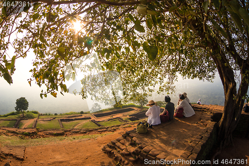 Image of Group of unrecognizable tourists enjoying amazing view from mount Sigiriya, Sri Lanka, Ceylon. Sigiriya, Lion rock, is a large stone and ancient palace ruin in the central Sri Lanka