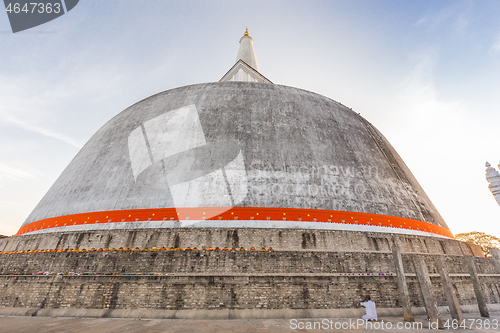 Image of Buddhist praying at Ruwanwelisaya stupa, in Anuradhapura historical park, Sri Lanka.