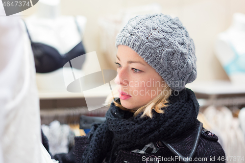 Image of Beautiful lady shopping in lingerie store.