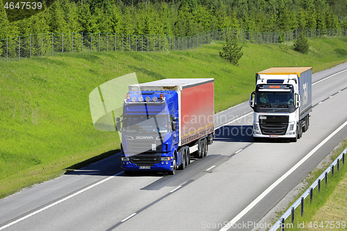 Image of Truck Overtakes Another on Freeway