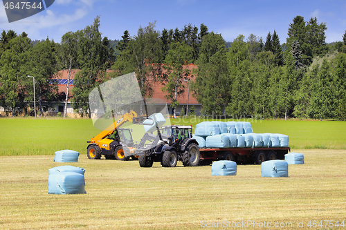 Image of JCB Reach Forklift Stacking Bales onto Trailer