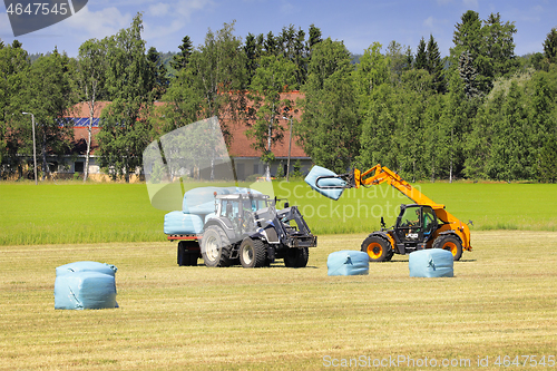 Image of JCB Telehandler Stacking Bales onto Trailer