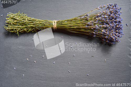 Image of A bunch of lavender flowers on on stone surface