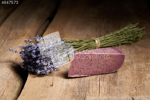 Image of Lavender cheese with bunch of fresh lavender flowers on rough wooden planks