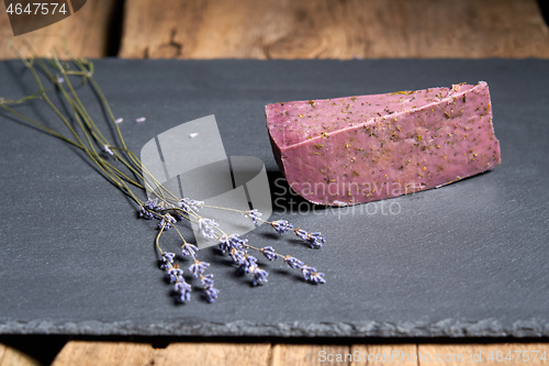 Image of Lavender cheese with bunch of fresh lavender flowers on rough wooden planks
