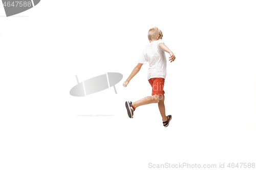 Image of Happy little caucasian boy jumping and running isolated on white background
