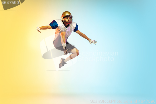 Image of American football player isolated on gradient studio background in neon light