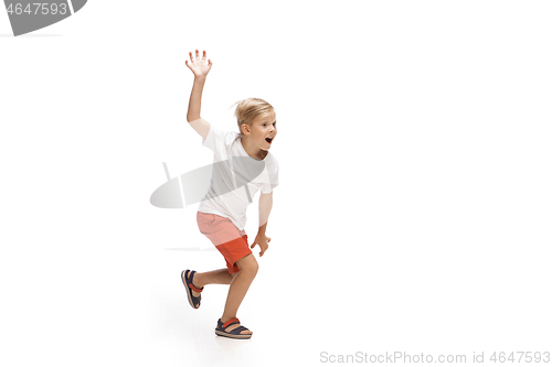 Image of Happy little caucasian boy jumping and running isolated on white background