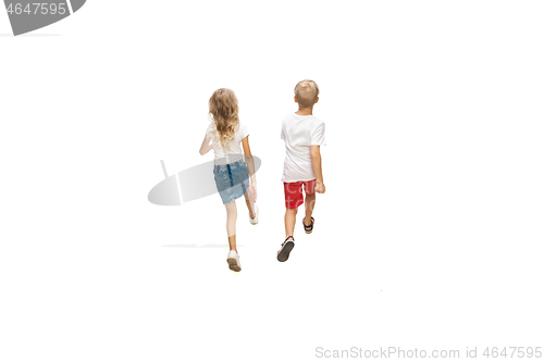 Image of Happy little caucasian girl and boy jumping and running isolated on white background