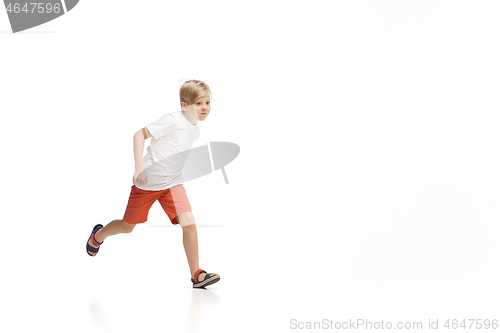 Image of Happy little caucasian boy jumping and running isolated on white background