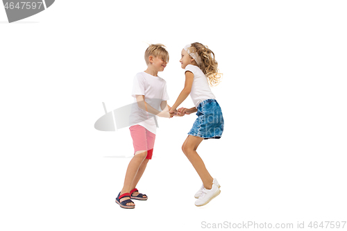 Image of Happy little caucasian girl and boy jumping and running isolated on white background