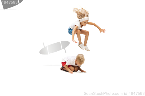 Image of Happy little caucasian girl and boy jumping and running isolated on white background