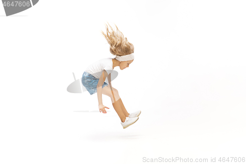 Image of Happy little caucasian girl jumping and running isolated on white background