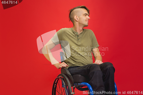 Image of Caucasian young man\'s portrait isolated on red studio background. Human emotions concept