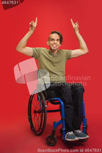 Image of Caucasian young man\'s portrait isolated on red studio background. Human emotions concept