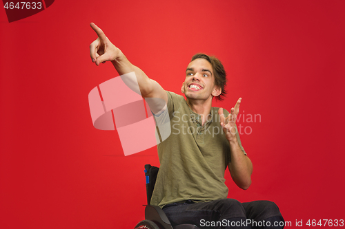 Image of Caucasian young man\'s portrait isolated on red studio background. Human emotions concept