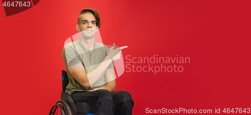 Image of Caucasian young man\'s portrait isolated on red studio background. Human emotions concept