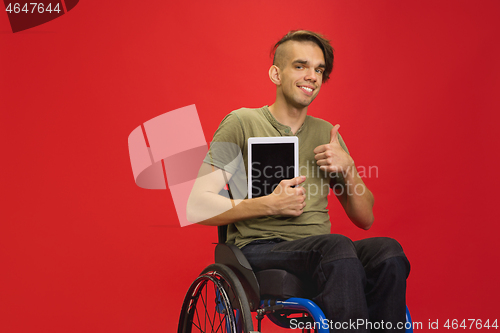 Image of Caucasian young man\'s portrait isolated on red studio background. Human emotions concept