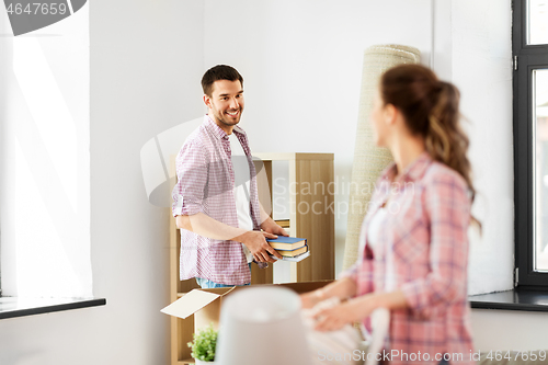 Image of happy couple with stuff moving to new home