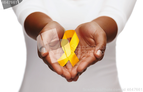 Image of hands holding yellow gold cancer awareness ribbon