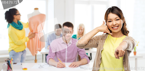 Image of african asian making phone call gesture