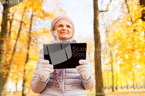 Image of senior woman with tablet pc at summer park