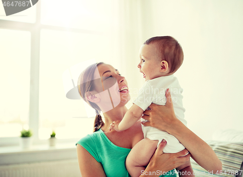 Image of happy young mother with little baby at home