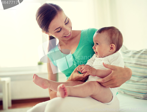 Image of happy young mother with little baby at home