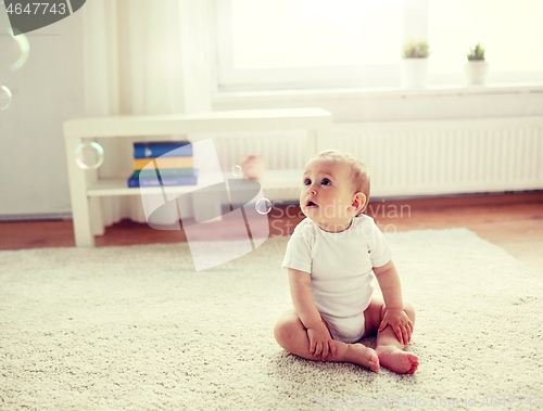 Image of happy baby with soap bubbles at home