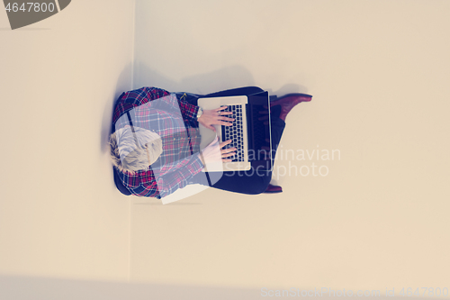 Image of top view of young business woman working on laptop computer