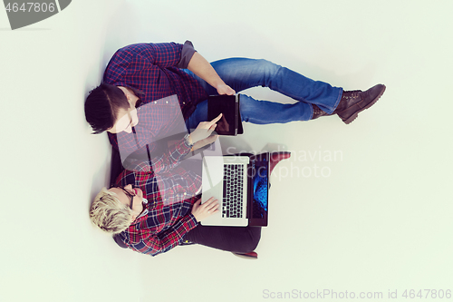 Image of top view of  couple working on laptop computer at startup office