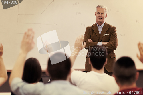 Image of teacher with a group of students in classroom