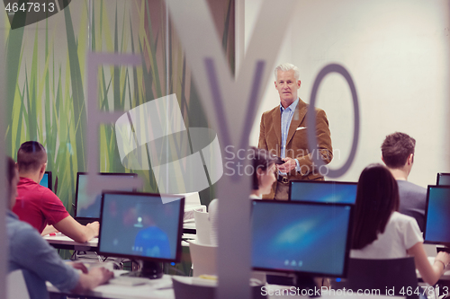 Image of teacher and students in computer lab classroom