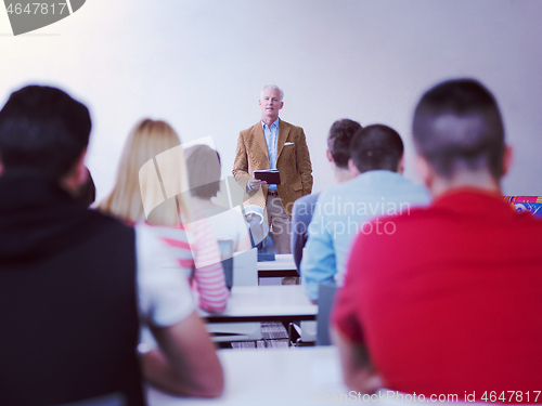 Image of teacher with a group of students in classroom