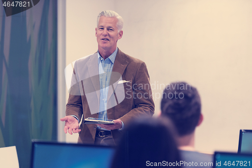 Image of teacher and students in computer lab classroom