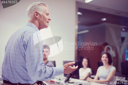 Image of teacher and students in computer lab classroom