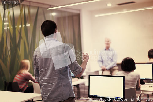 Image of student answering a question in classroom