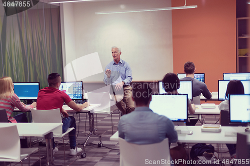 Image of teacher and students in computer lab classroom